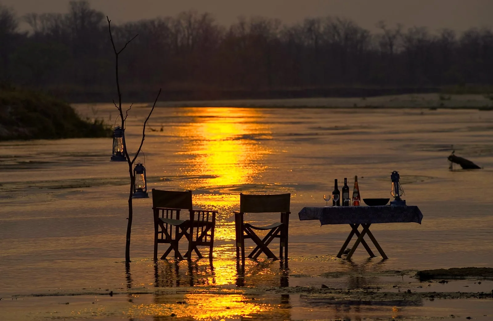 Private sundowners in the middle of the river at Zungulila Camp, Zambia.